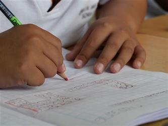 A student does schoolwork in a notebook.
